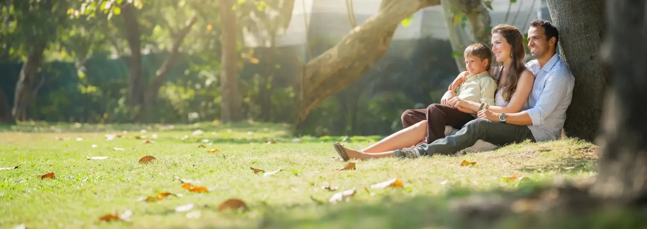 family sitting by tree